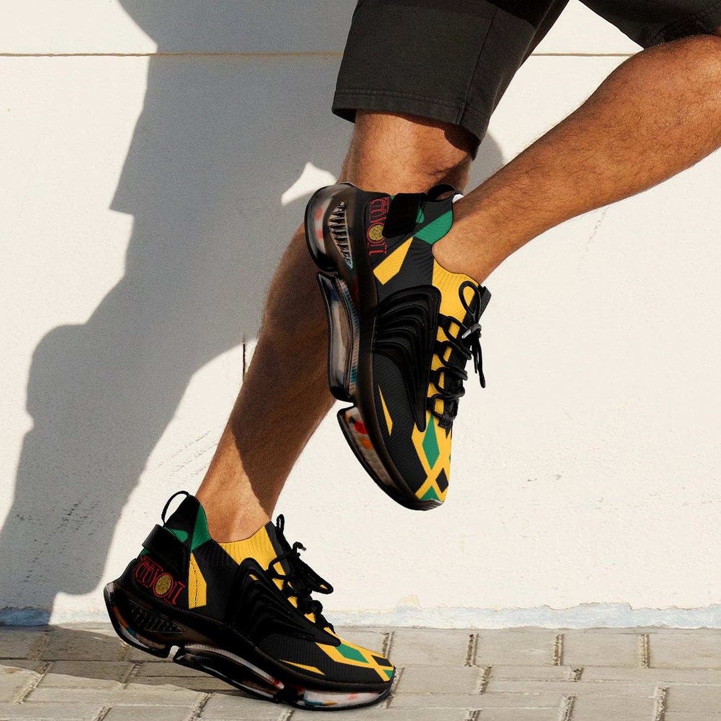 Person wearing black and yellow sneakers with colorful accents on a light background
