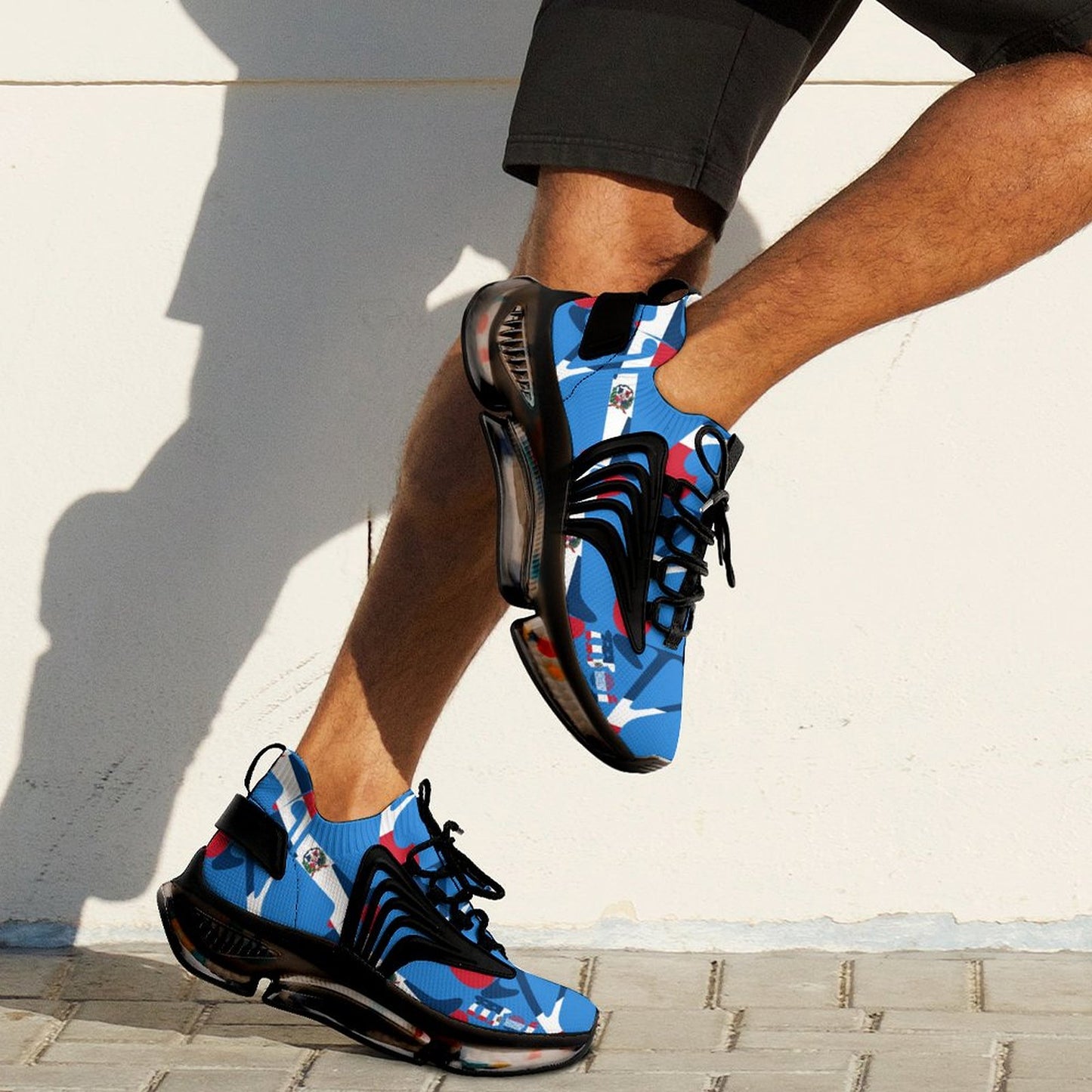 Blue and black sneakers with red accents worn by a person on a light background