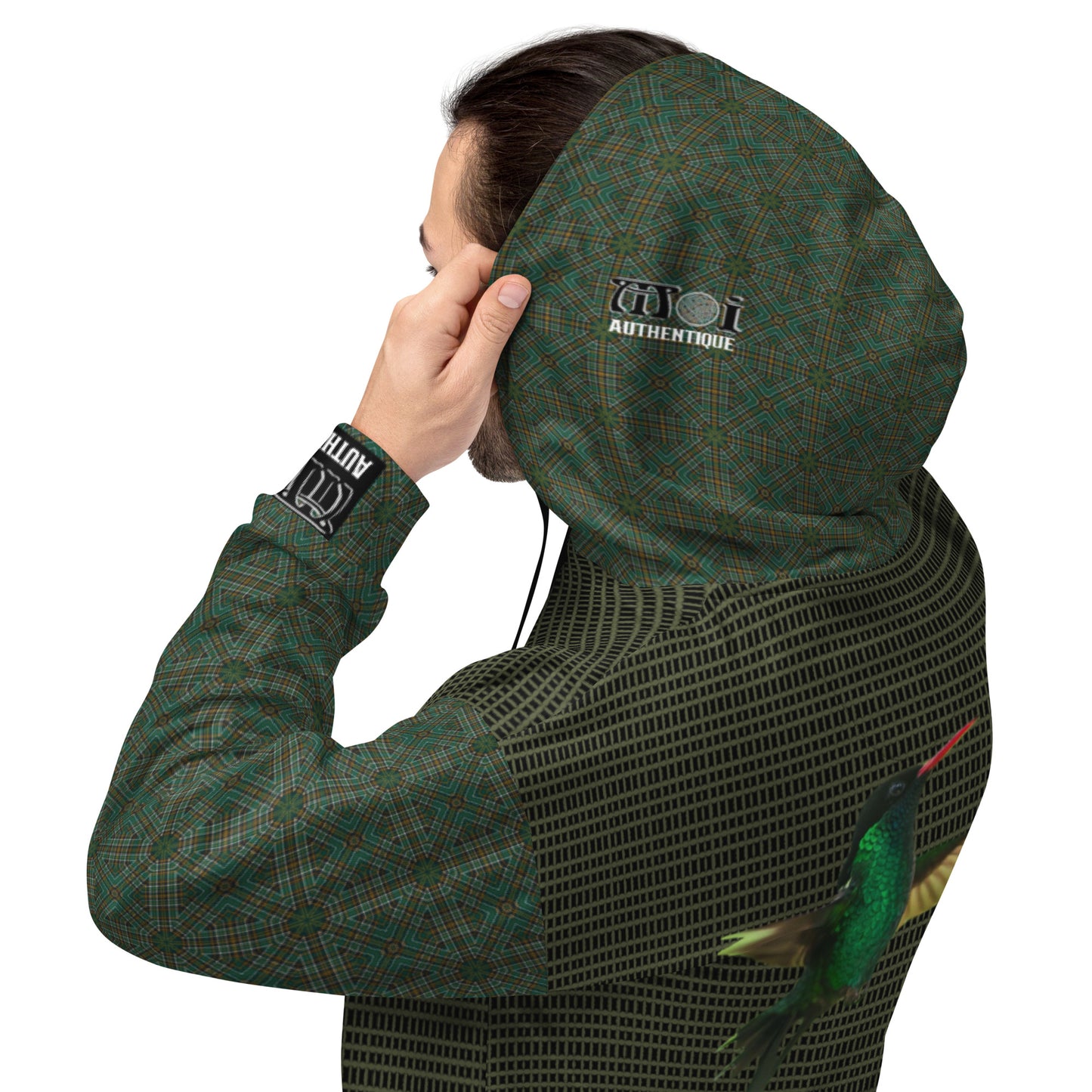 A person wearing a green hooded jacket with a brand logo, holding their head with one hand.