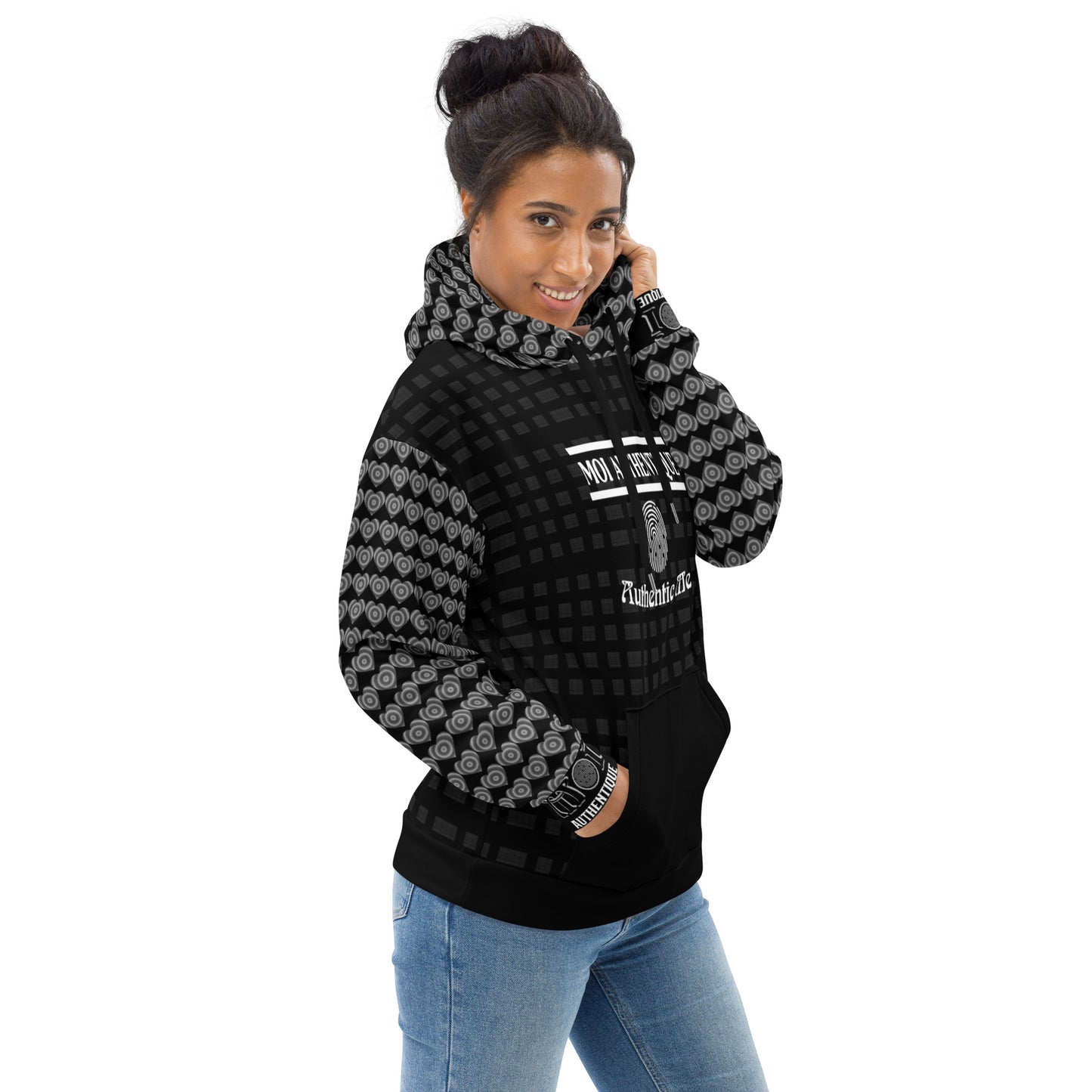 Woman wearing a black and gray patterned hoodie with blue jeans on a white background