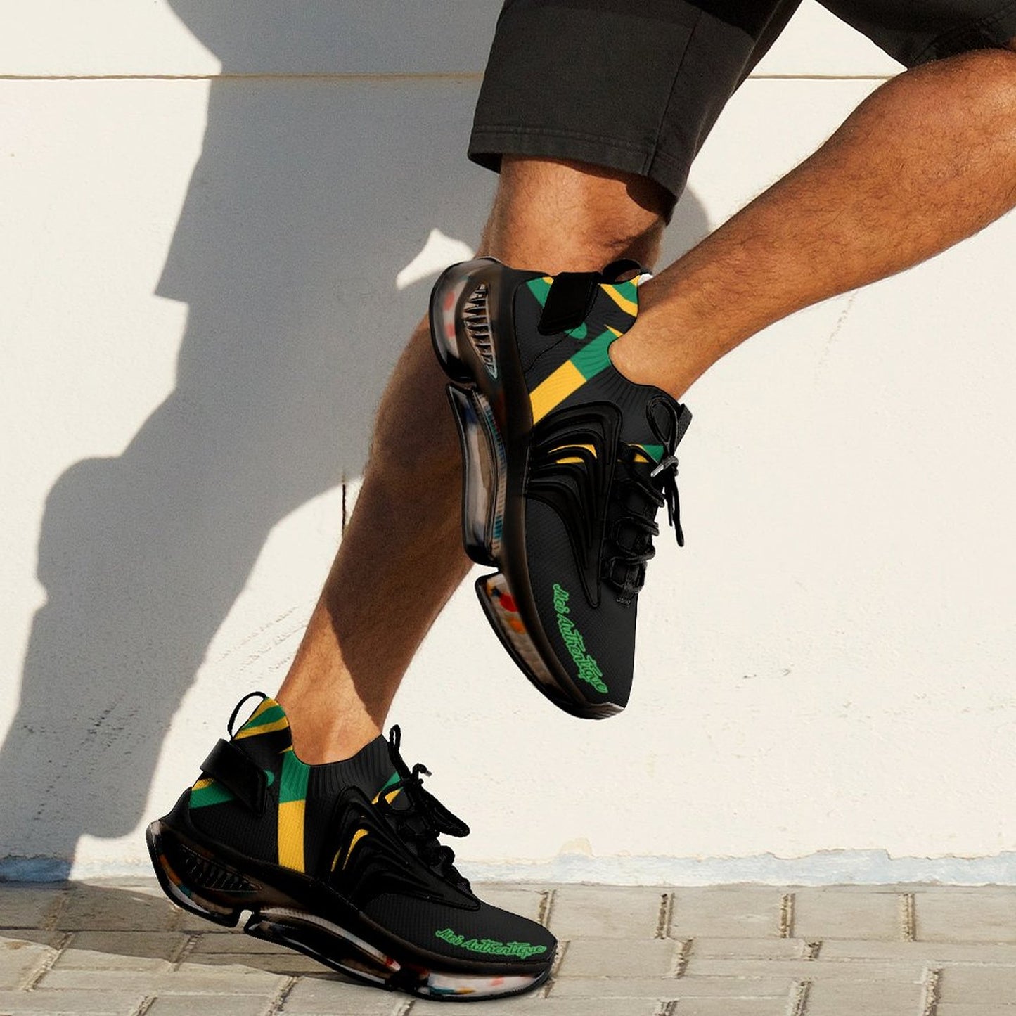 Person wearing black athletic shoes with green and yellow accents on a light background